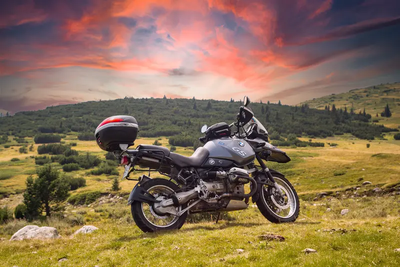 BMW GS against dramatic sunset sky — Bulgarian mountains