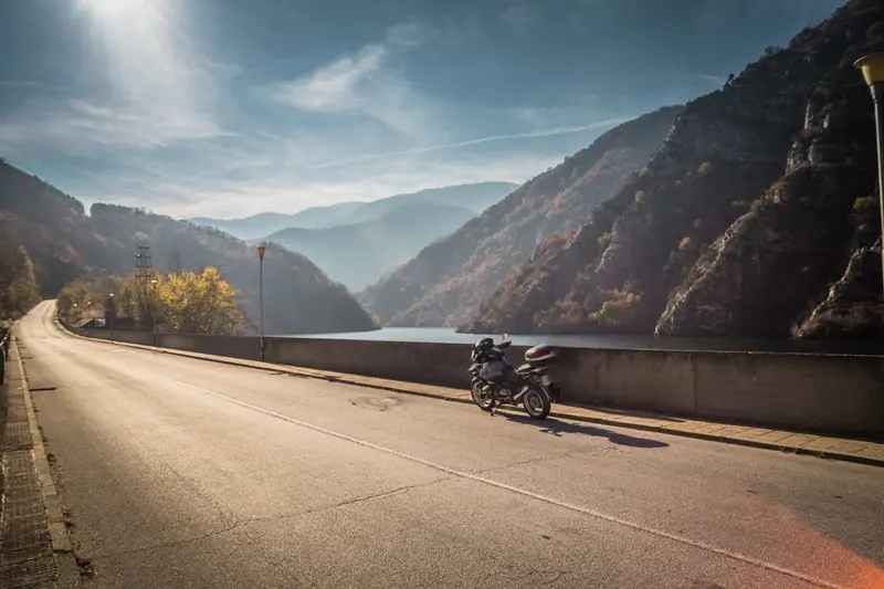 BMW R1150GS on dam road in autumn light — Bulgaria