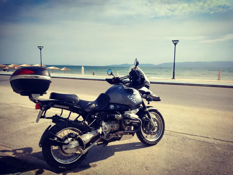BMW R1150GS on mountain ridge above the sea — Sardinia